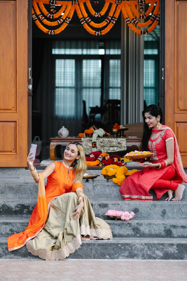 Women In Traditional Dresses Taking Picture On Mobile