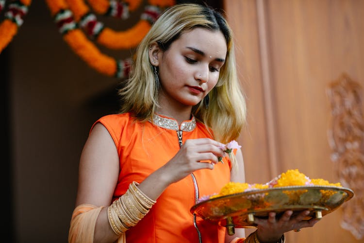 Young Woman Holding A Platter Of Food.