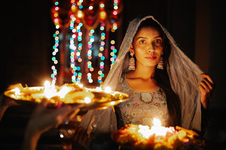 Woman In Traditional Clothes At Ceremony At Night