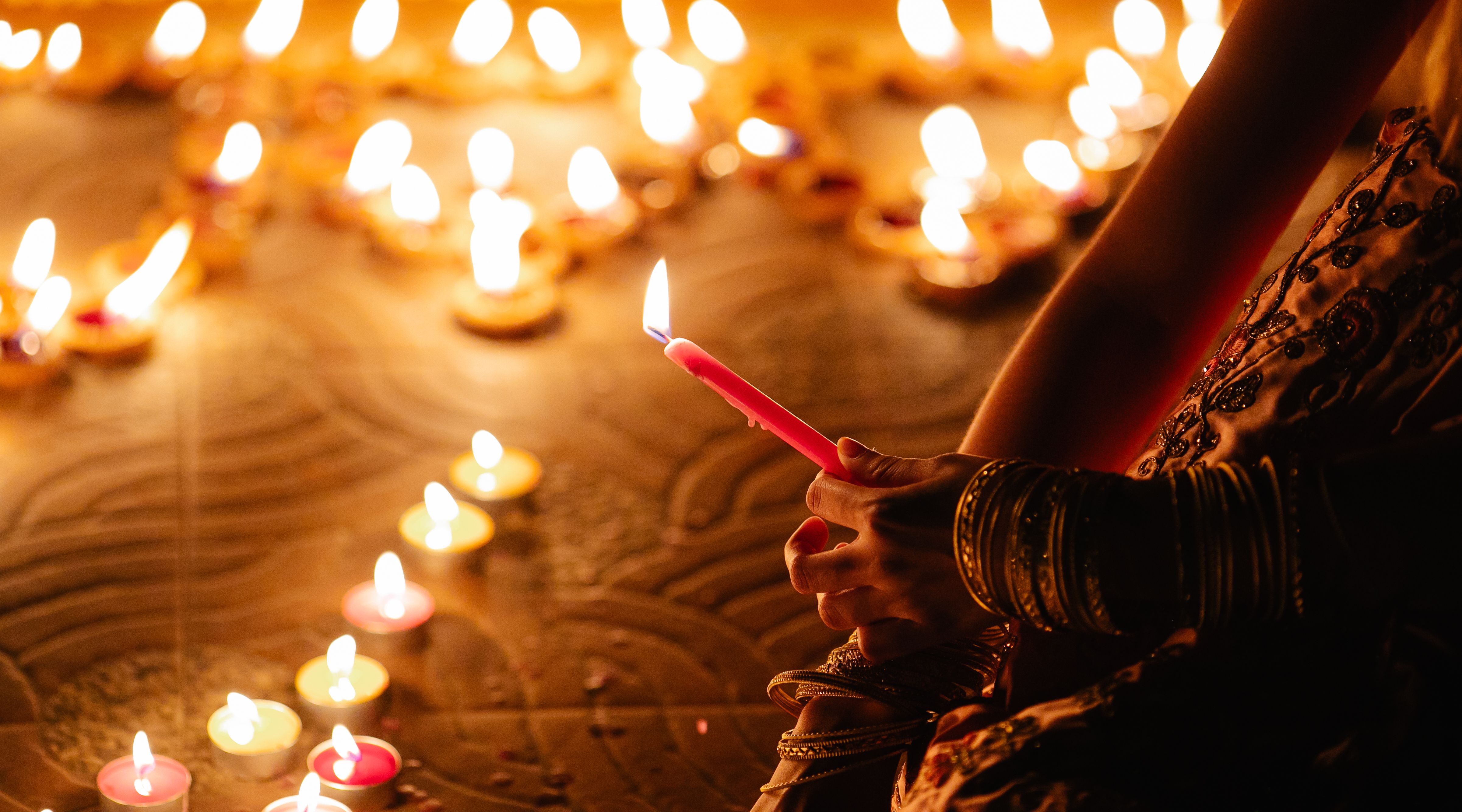Golden oil lamps and flower petals arranged for a Diwali celebration