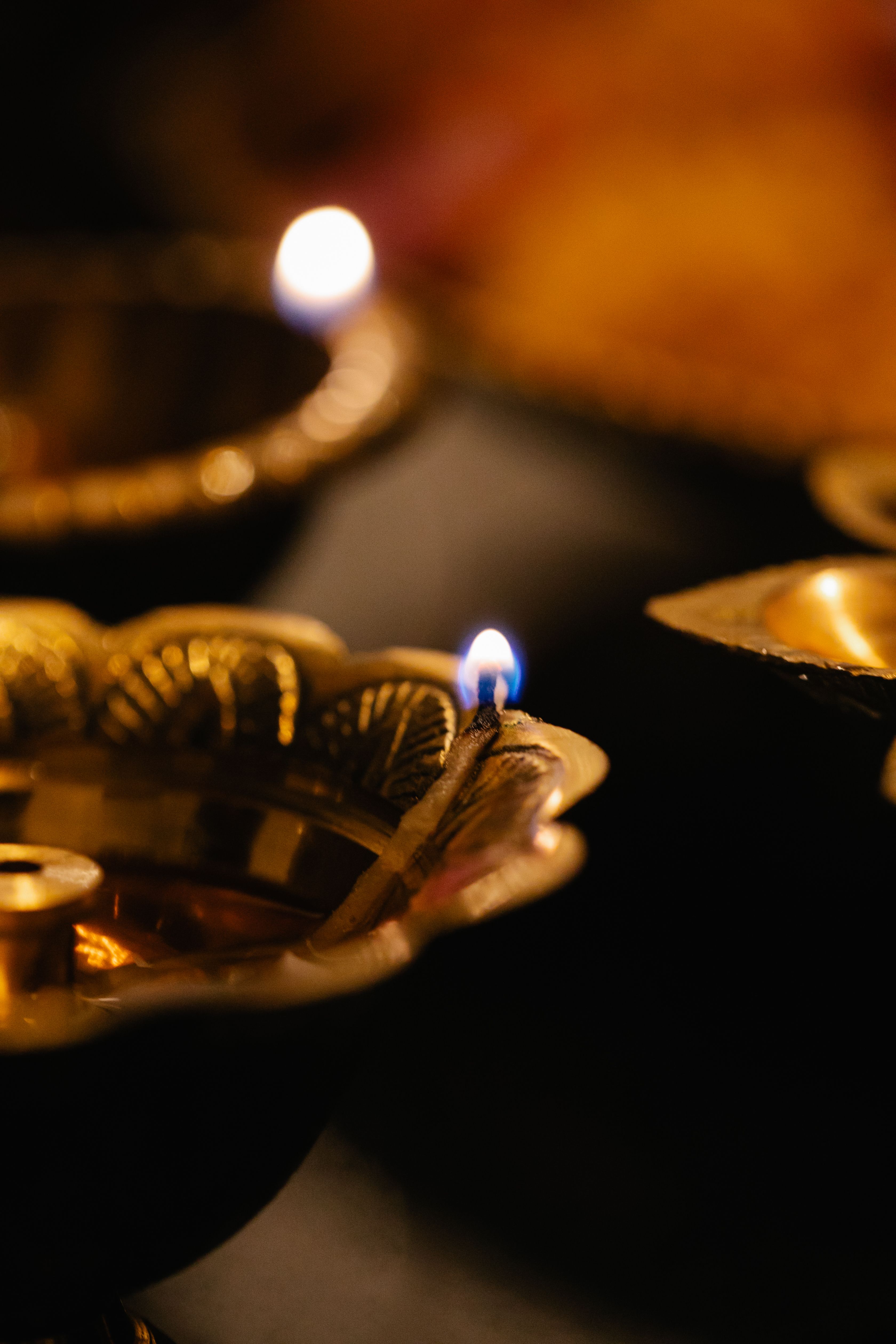 Beautiful close-up of a lit traditional brass oil lamp, symbolizing warmth and spirituality.