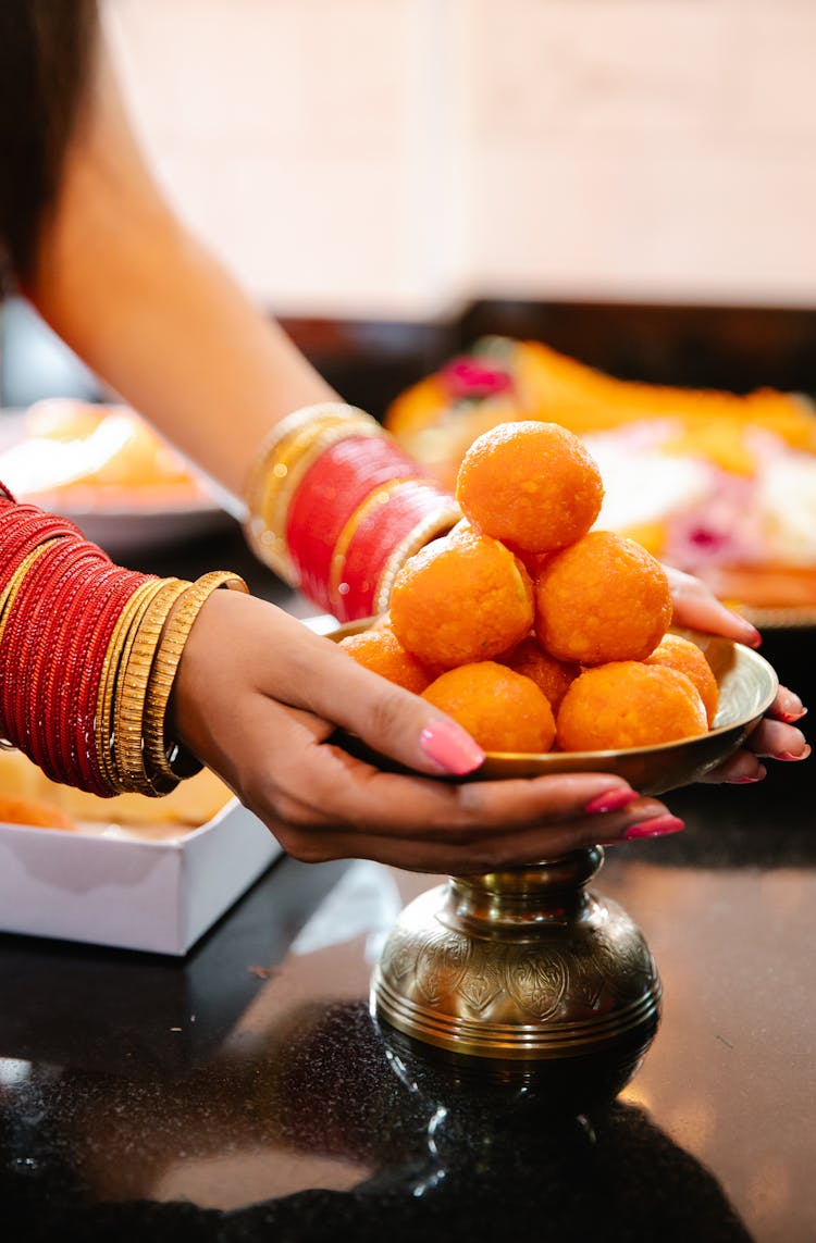 Woman Grabbing A Bowl With Food 