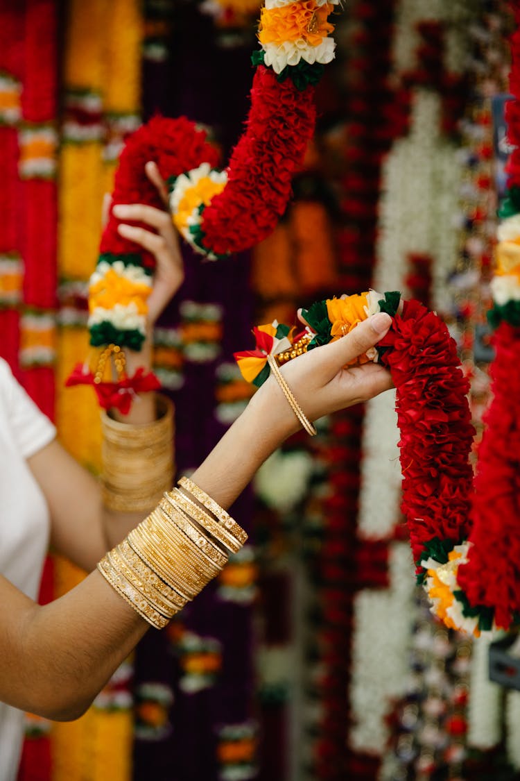 Woman Touching An Artificial Flower Garland 