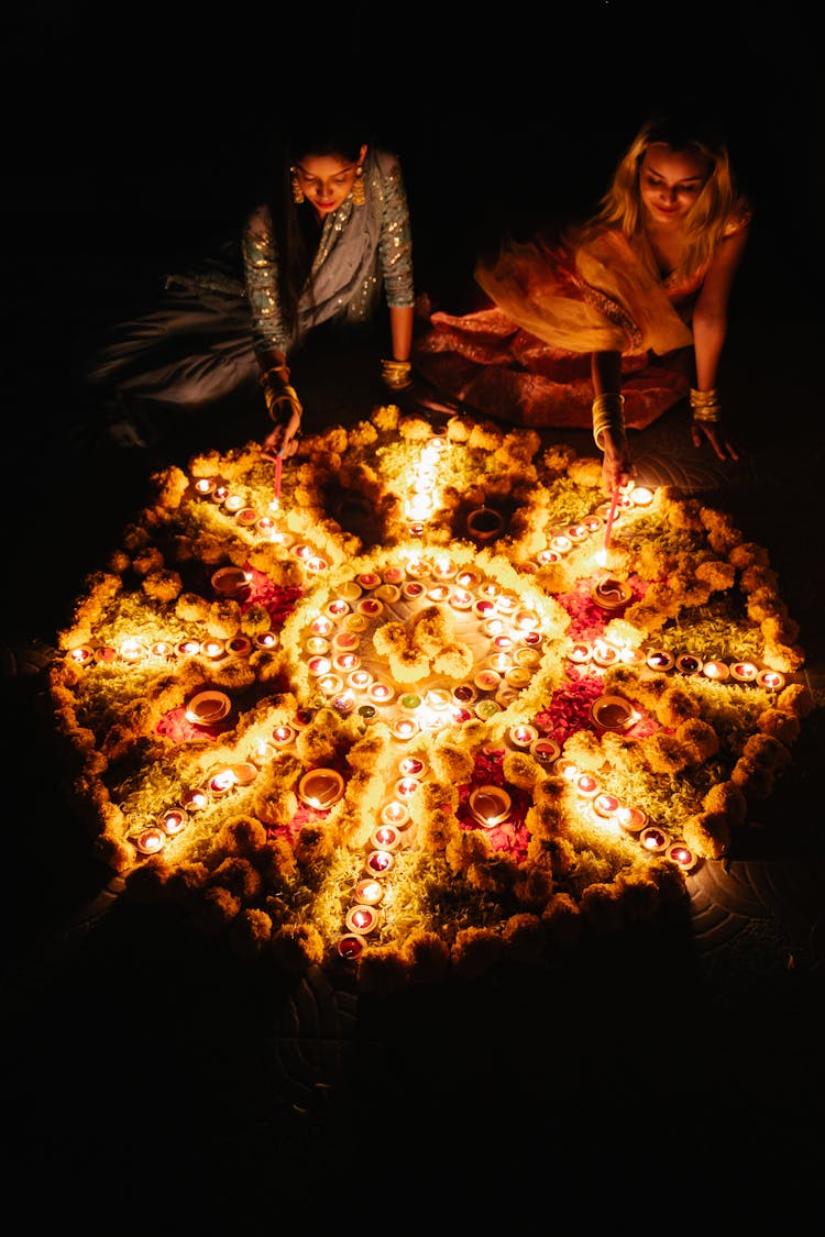 Women Lighting Candles On Traditional Ceremony