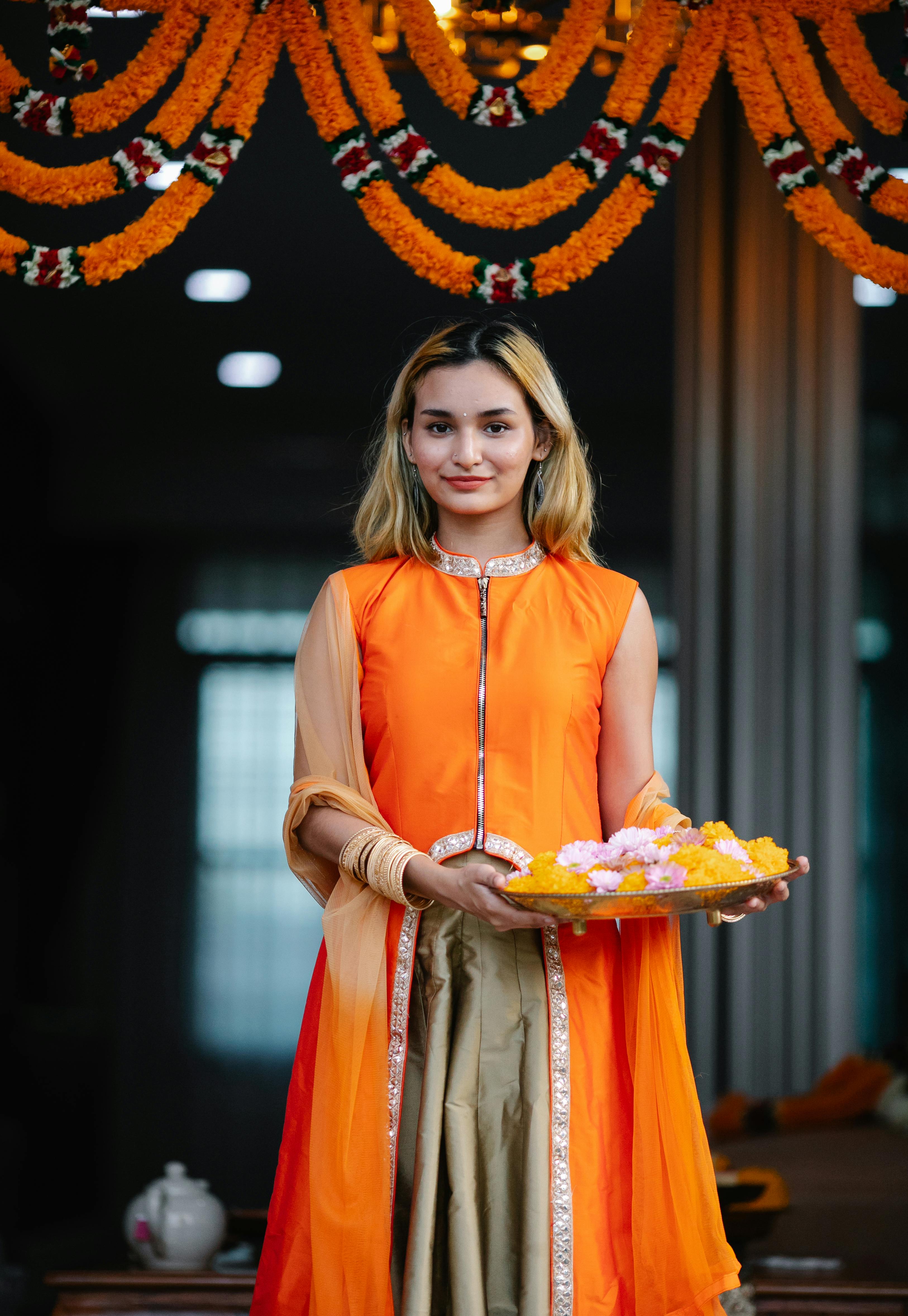 Orange chicken garnished with sesame seeds and scallions in a bowl