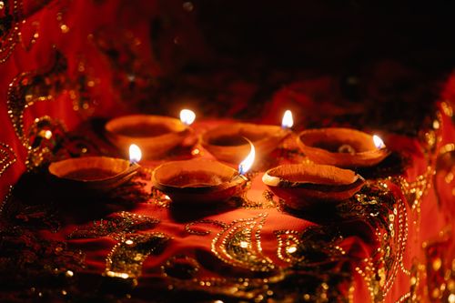 Oil lamps on embroidered fabric