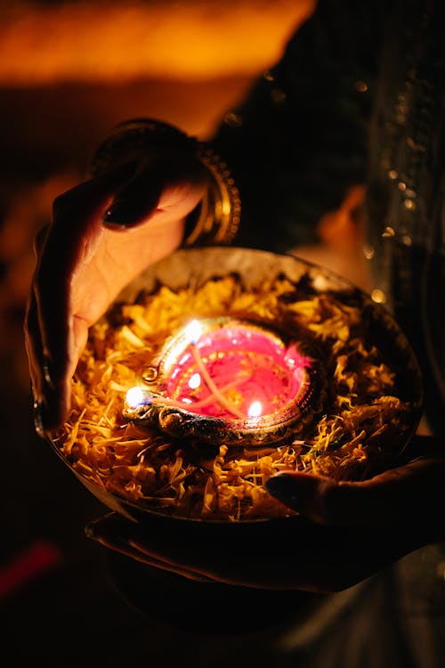 Free Close-up of Woman Holding a Decoration with a Burning Candle  Stock Photo