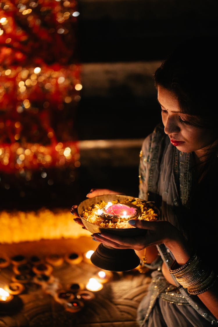 Woman With Bowl With Candle Celebrating Festival