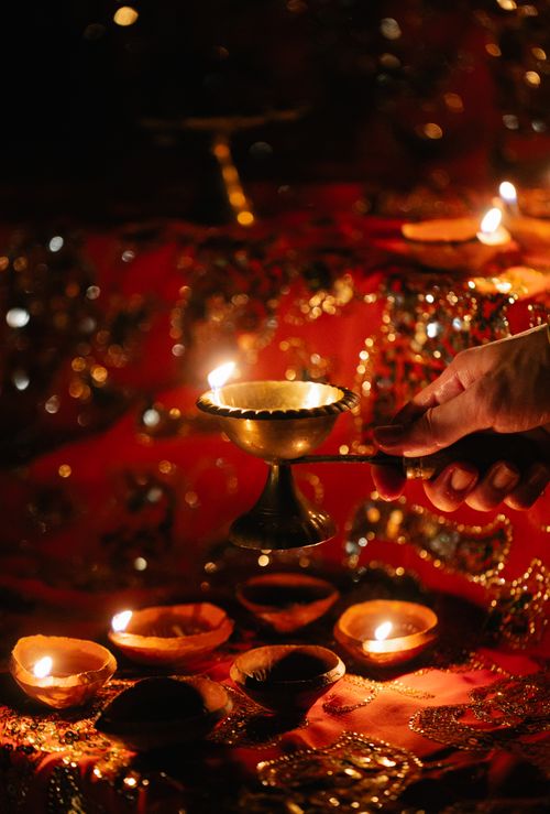 Free Close-up of traditional Indian ceremony with candles and decorated fabrics at night. Stock Photo