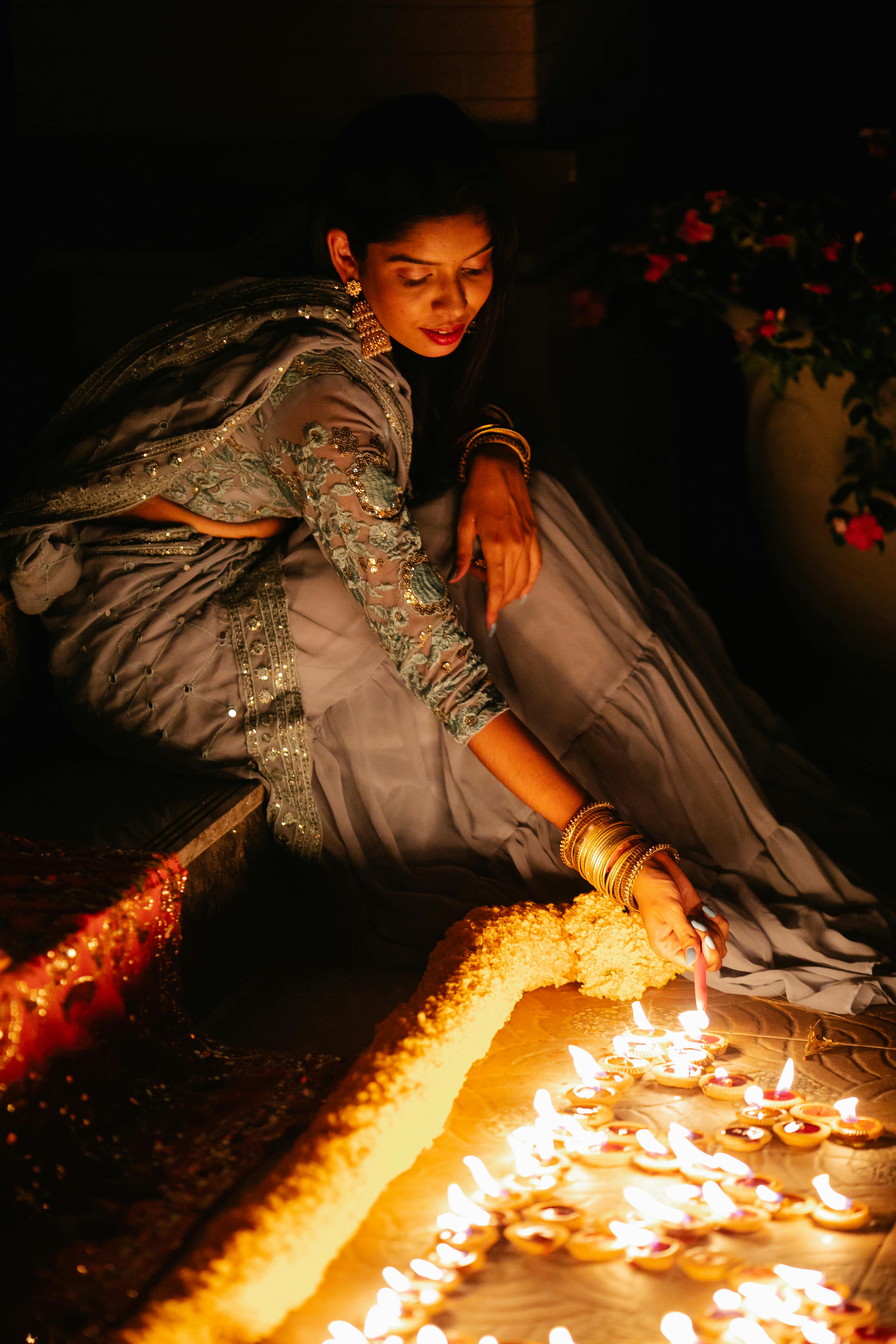 Free Photos - A Beautiful Indian Woman Dressed In Traditional Garb, Adorned  With Jewelry, And Holding A Lit Candle In Her Hands. She Appears To Be  Posing For A Photo, Exuding An
