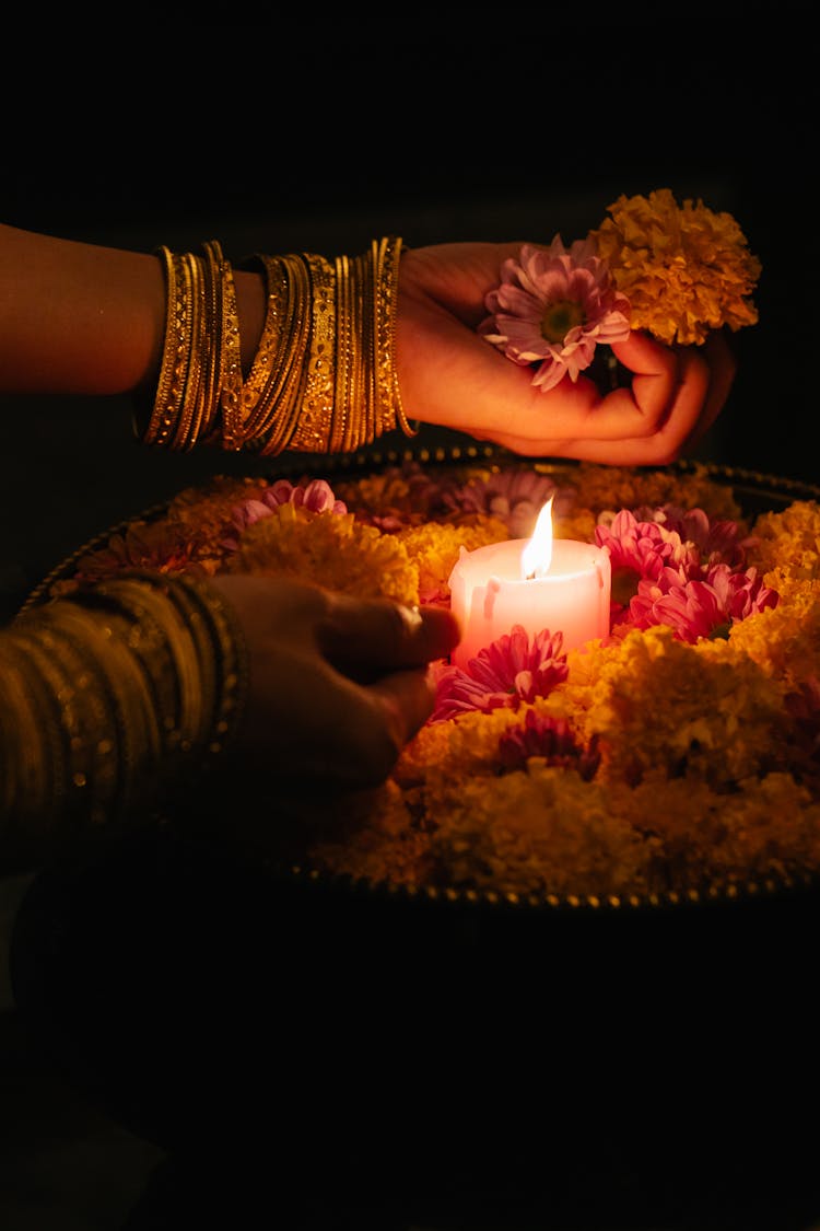 Close-up Of Woman Lighting Candle For Ceremony