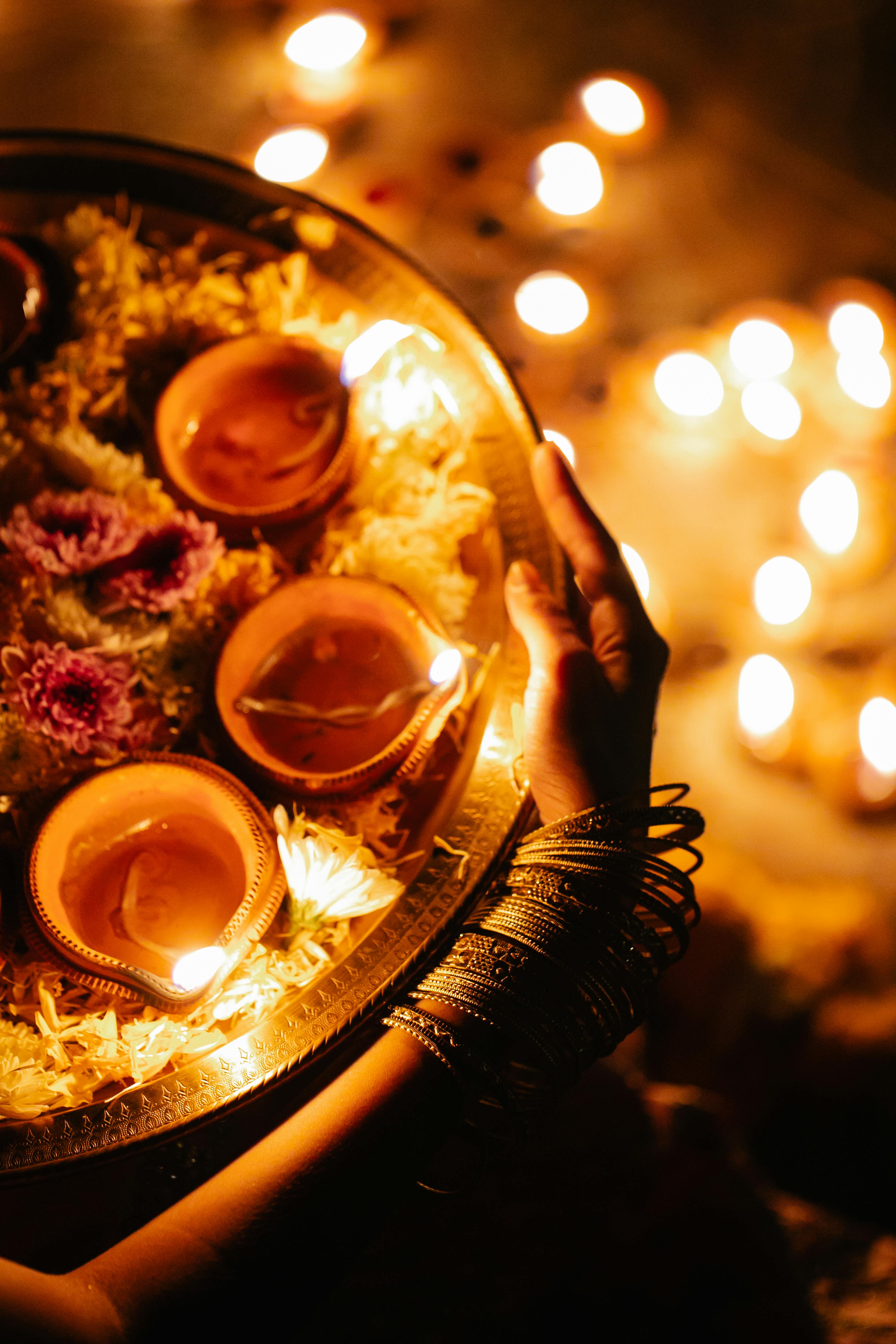 Woman holding diya platter during traditional Muhurat ceremony