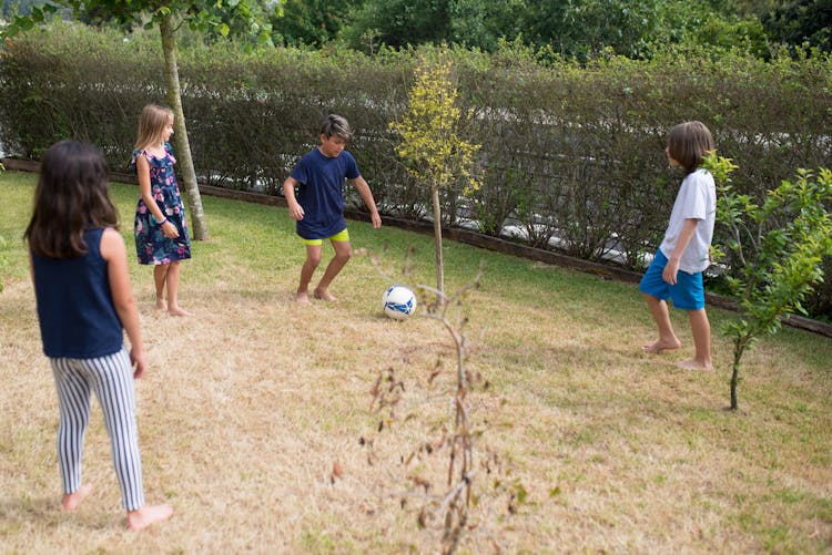 Group Of Kid Playing Football