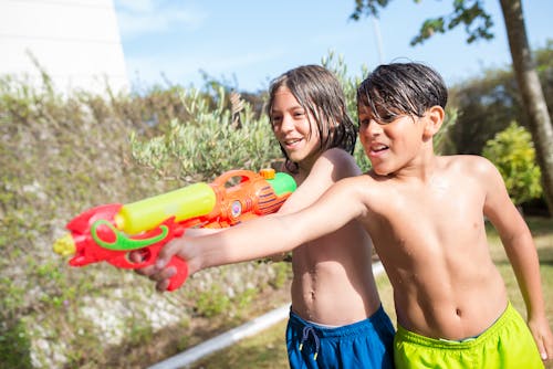 Shirtless Boys Playing with Water Guns