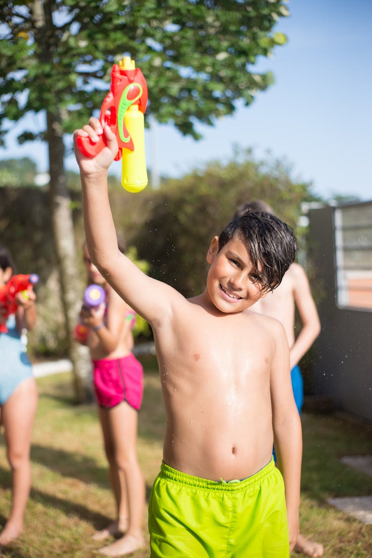 Shirtless Kid Holding A Water Gun