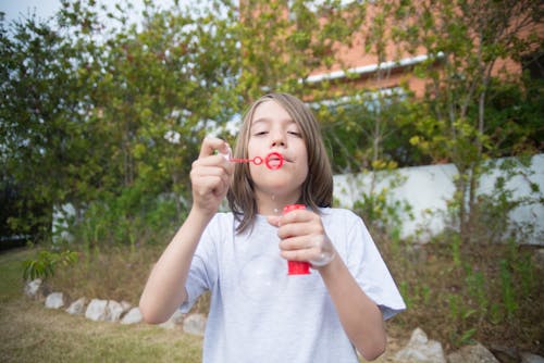 Kid Playing with Soap Bubbles