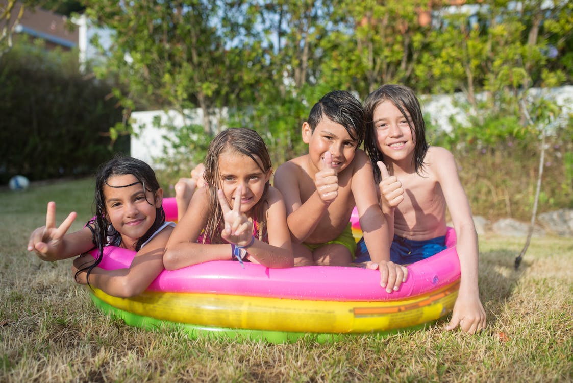 Free 4 Women in Inflatable Ring on Green Grass Stock Photo