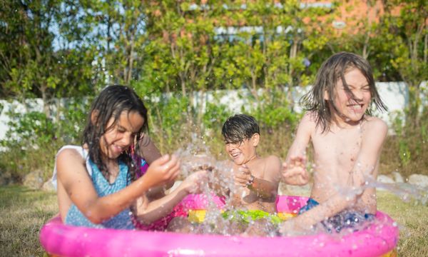 Children playing in inflatable pool