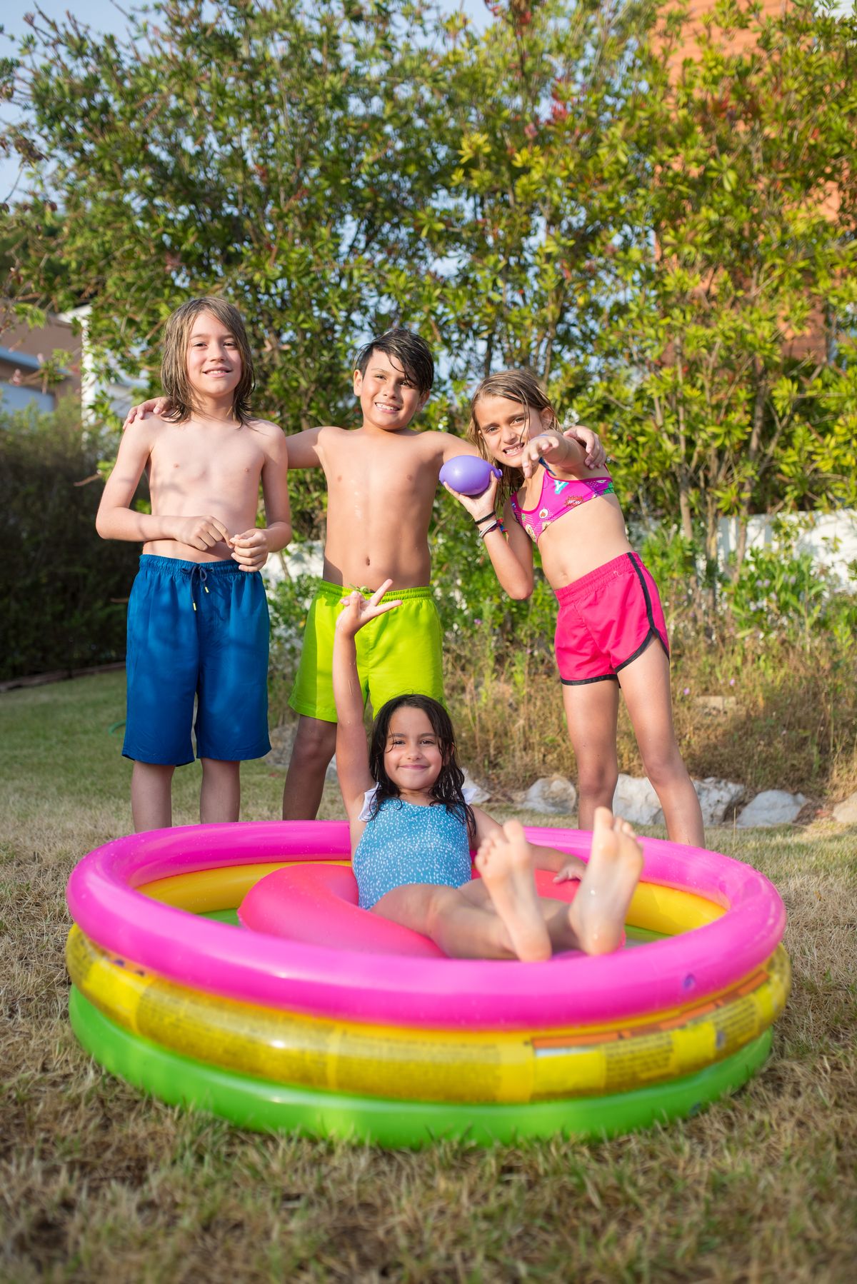 Kids playing in a colorful inflatable kiddie pool