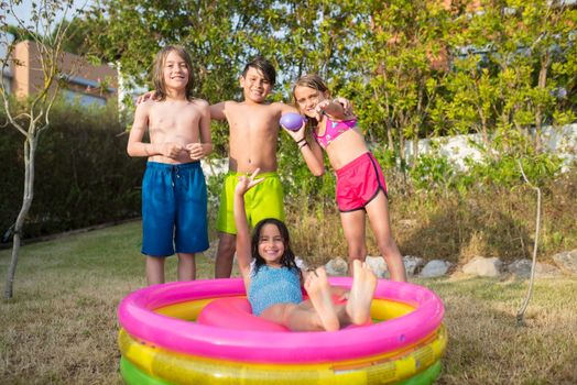 3 Women in Pink and Blue Shorts on Pink Inflatable Pool