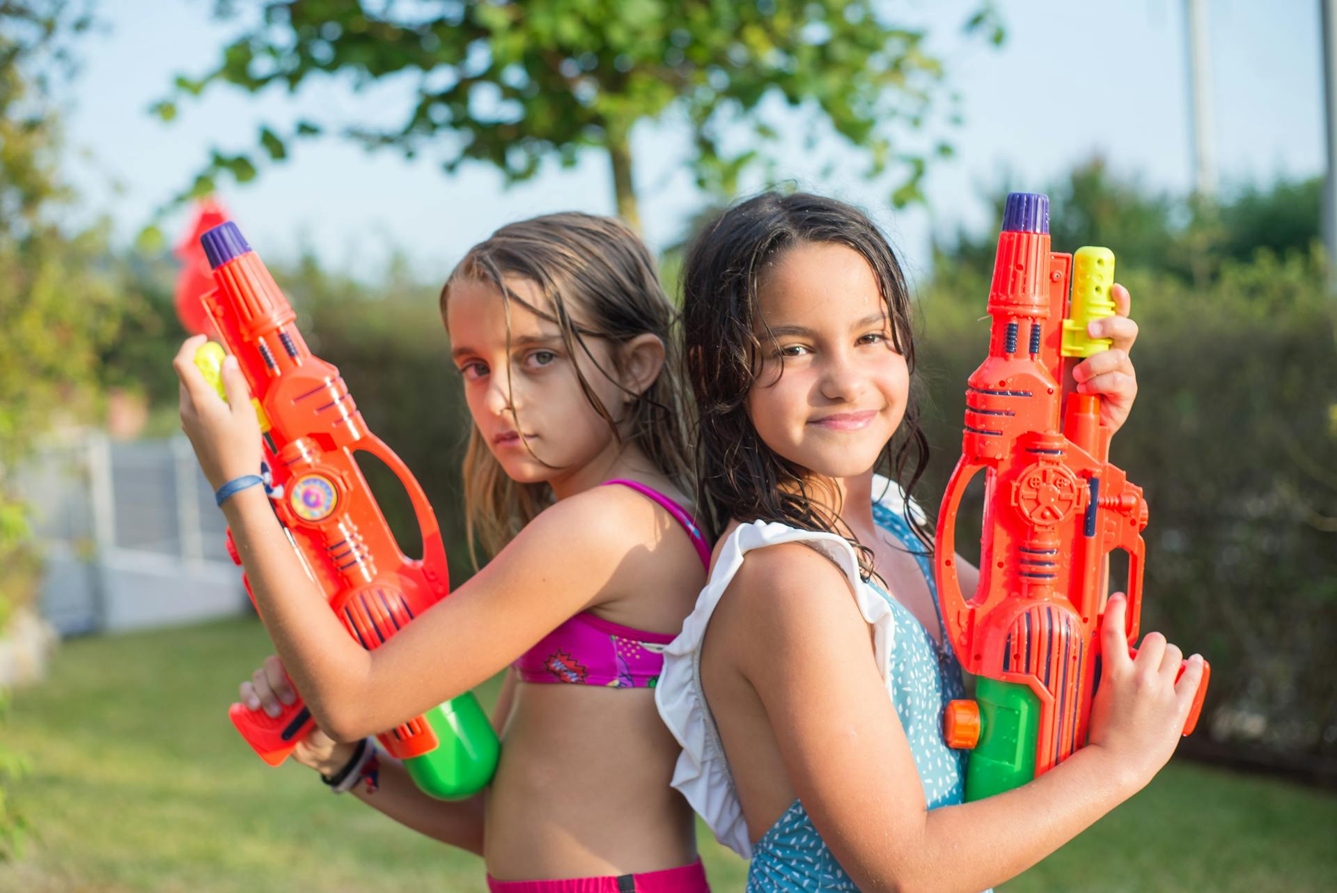 Girls in Swimsuit Holding Red Toy Gun