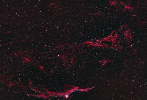 A captivating capture of the red-hued nebula amidst starry deep space.