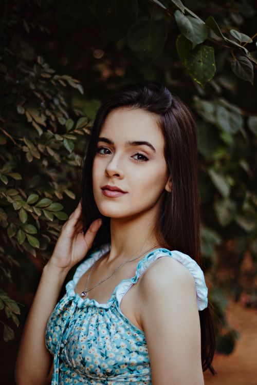Free Beautiful woman with long hair posing outdoors in nature. Stock Photo