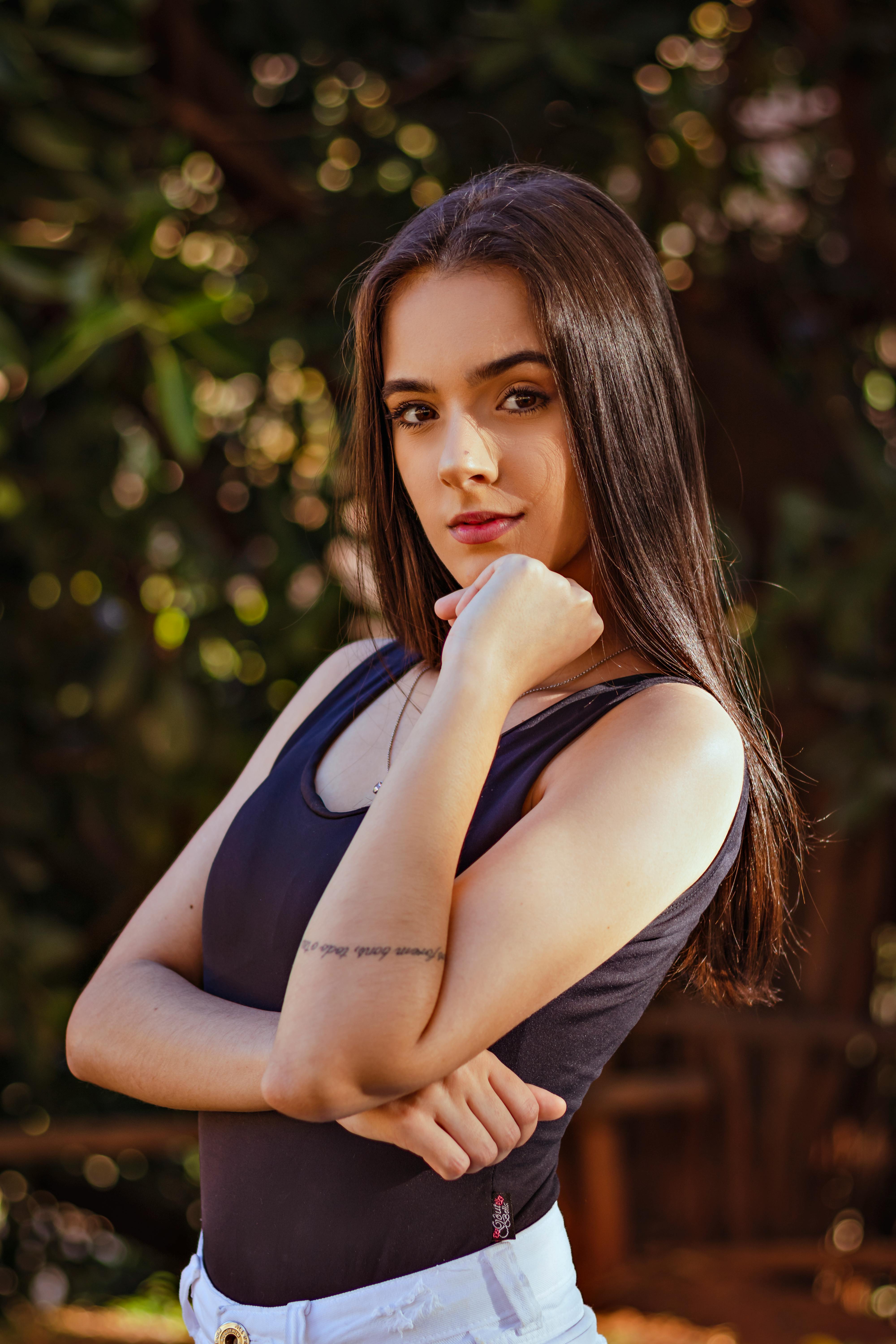 Woman with Long Black Hair Standing and Looking into Distance · Free ...