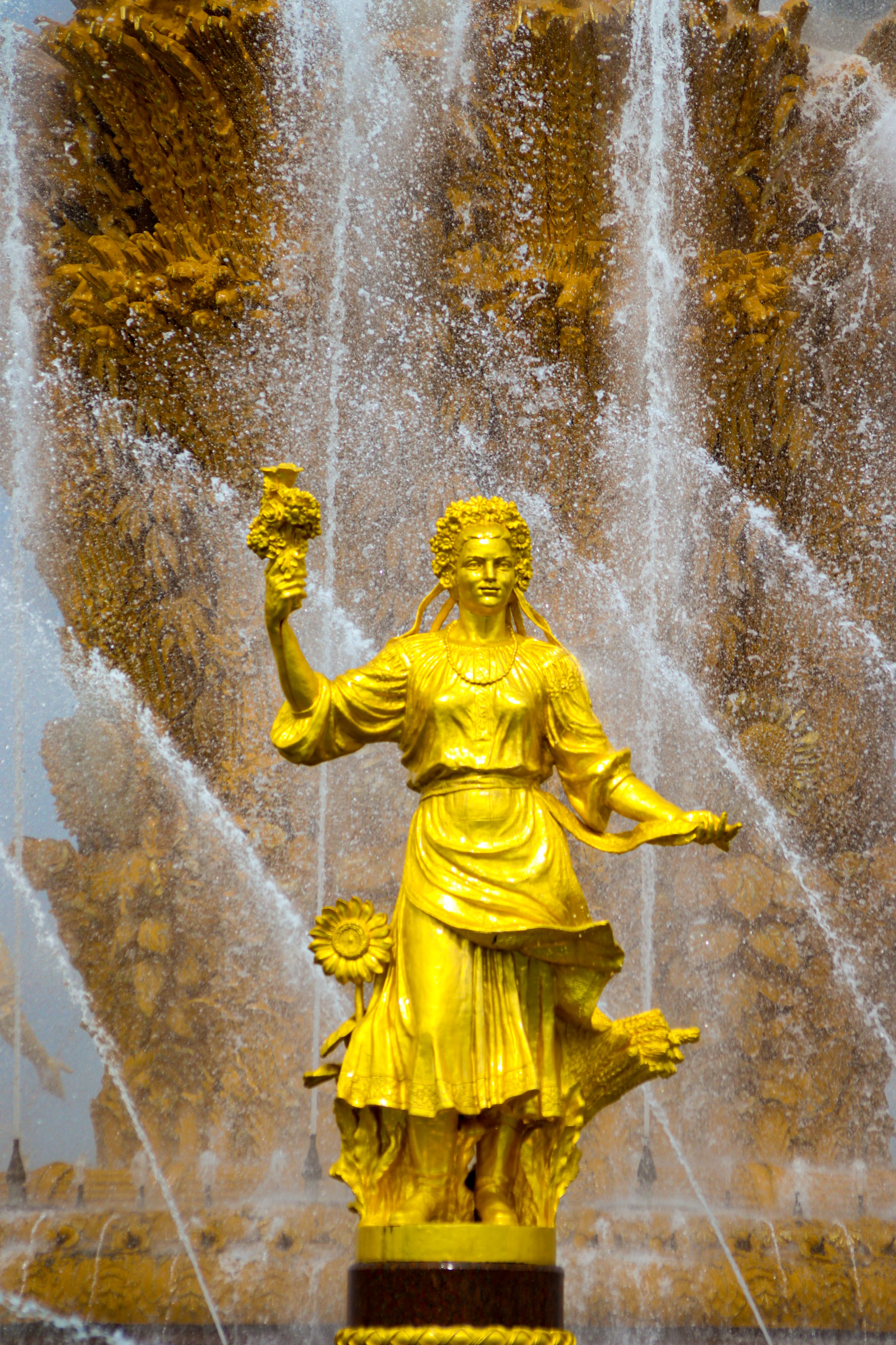Golden Statue with Fountain at the Back · Free Stock Photo
