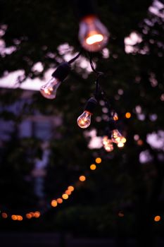 Outdoor string lights casting warm glow in Kharkiv, creating a serene and cozy atmosphere.
