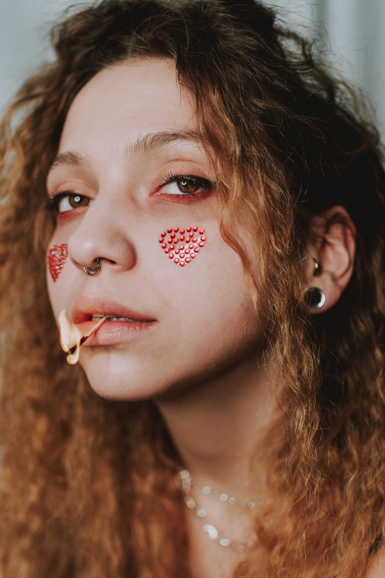 Close Up Shot Of A Woman With Match Stick On Her Lips