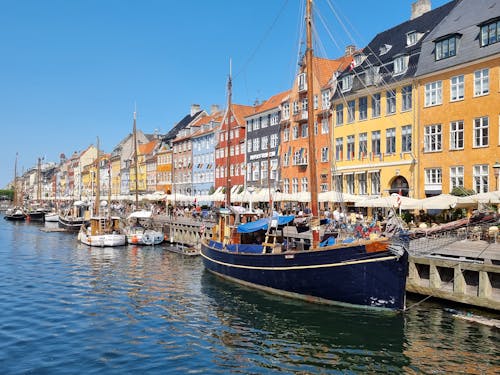 Boats on Dock on a Canal Near Colorful Buildings