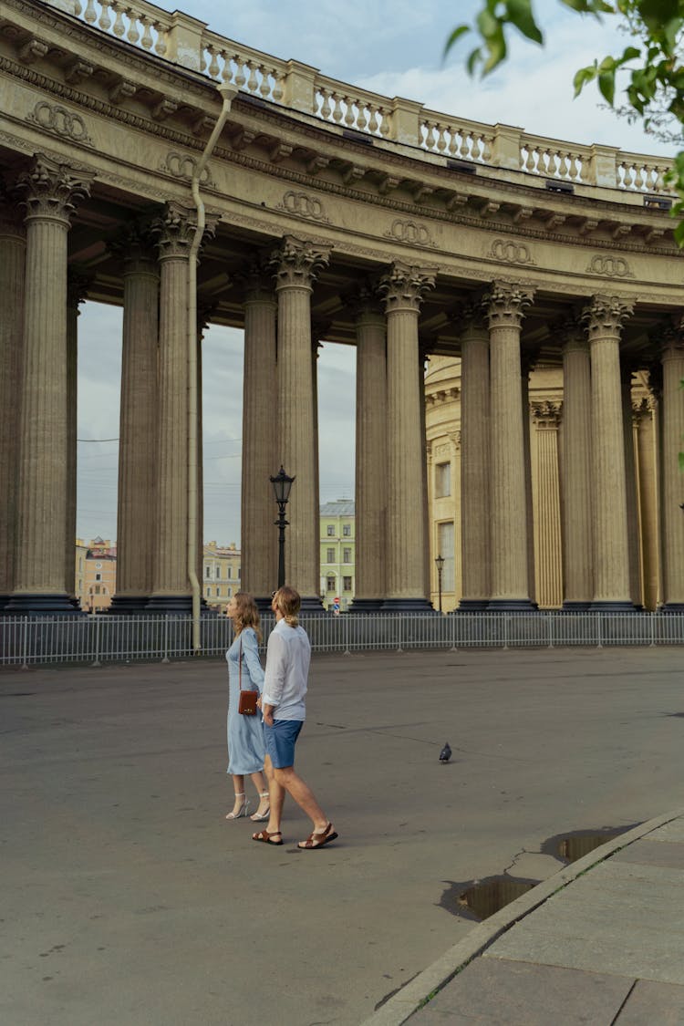  Couple Looking At Columns Of A Historical Building 