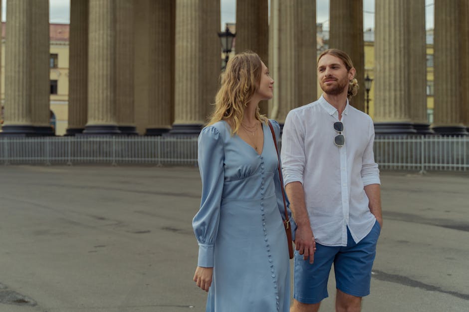 how to become a partner with best maya tours - A young couple walking near classical architecture, enjoying a sunny day.