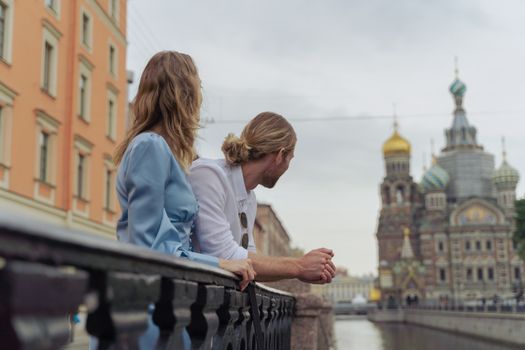 A couple admires the Church of the Savior on Spilled Blood in Saint Petersburg, Russia.