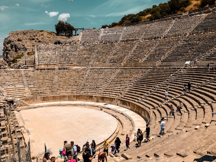 People Walking On The Theater Grandstand Made Of Stone