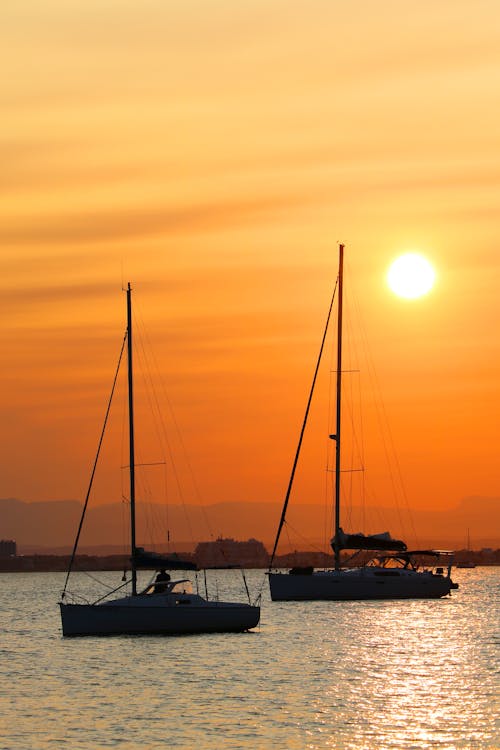 Sailboats on the Sea during Sunset
