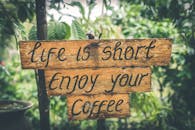Shallow Photography of Life Is Short Enjoy Your Coffee Signage
