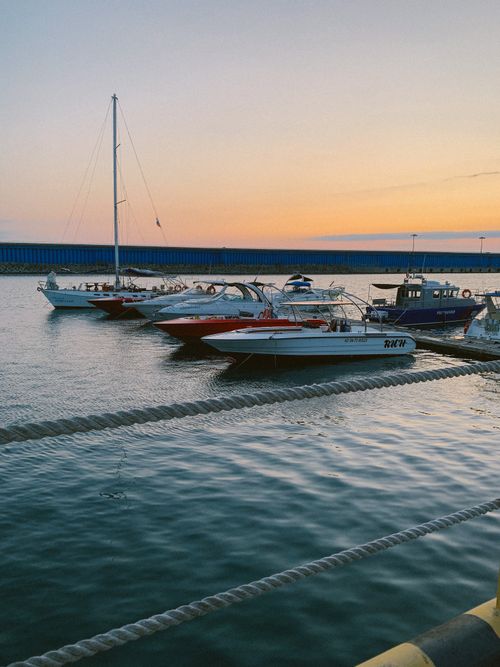 Free Beautiful marina view with speedboats docked at sunset, calm waters Stock Photo