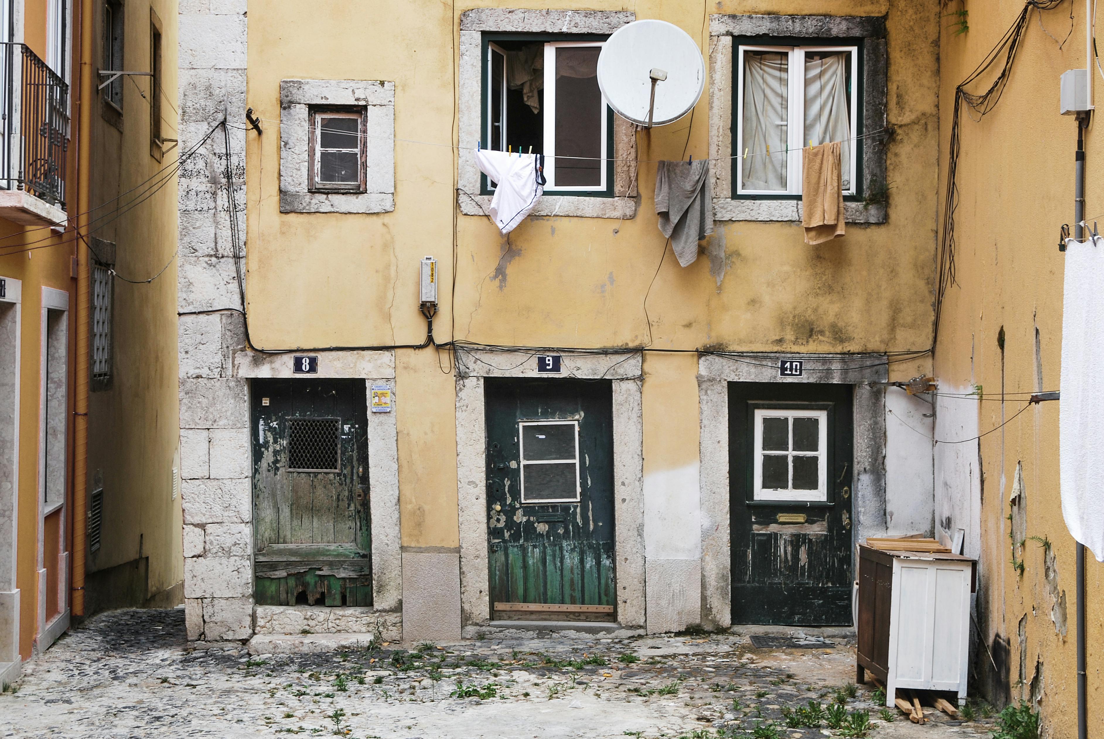 white parabolic antenna beside brown concrete building