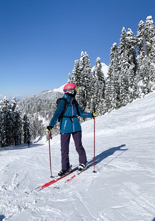 A Photo of a Person Riding Ski Blades on Snow Covered Ground