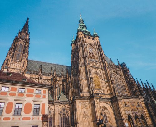 Free A breathtaking view of the Gothic St. Vitus Cathedral under a clear blue sky in Prague, Czech Republic. Stock Photo