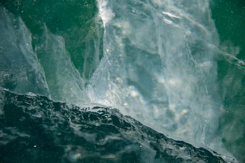 Free Textured close-up of ice formation in a body of water, highlighting natural patterns and colors. Stock Photo
