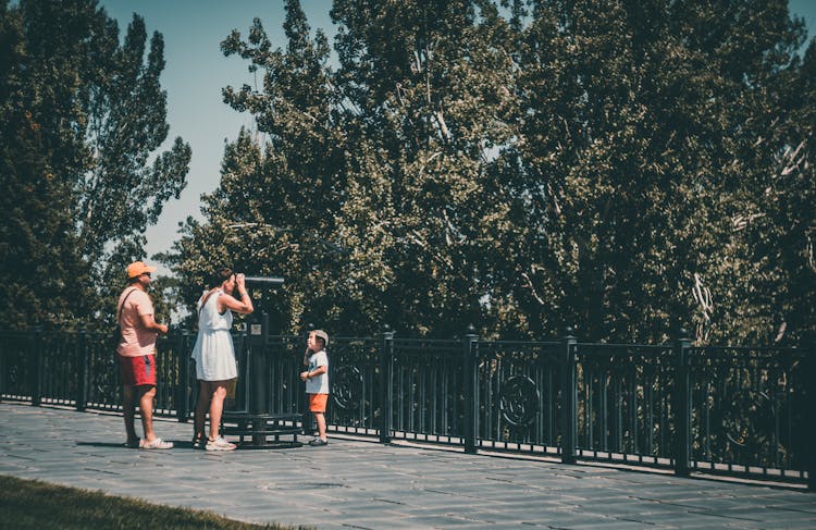 People Looking With Telescope In Park