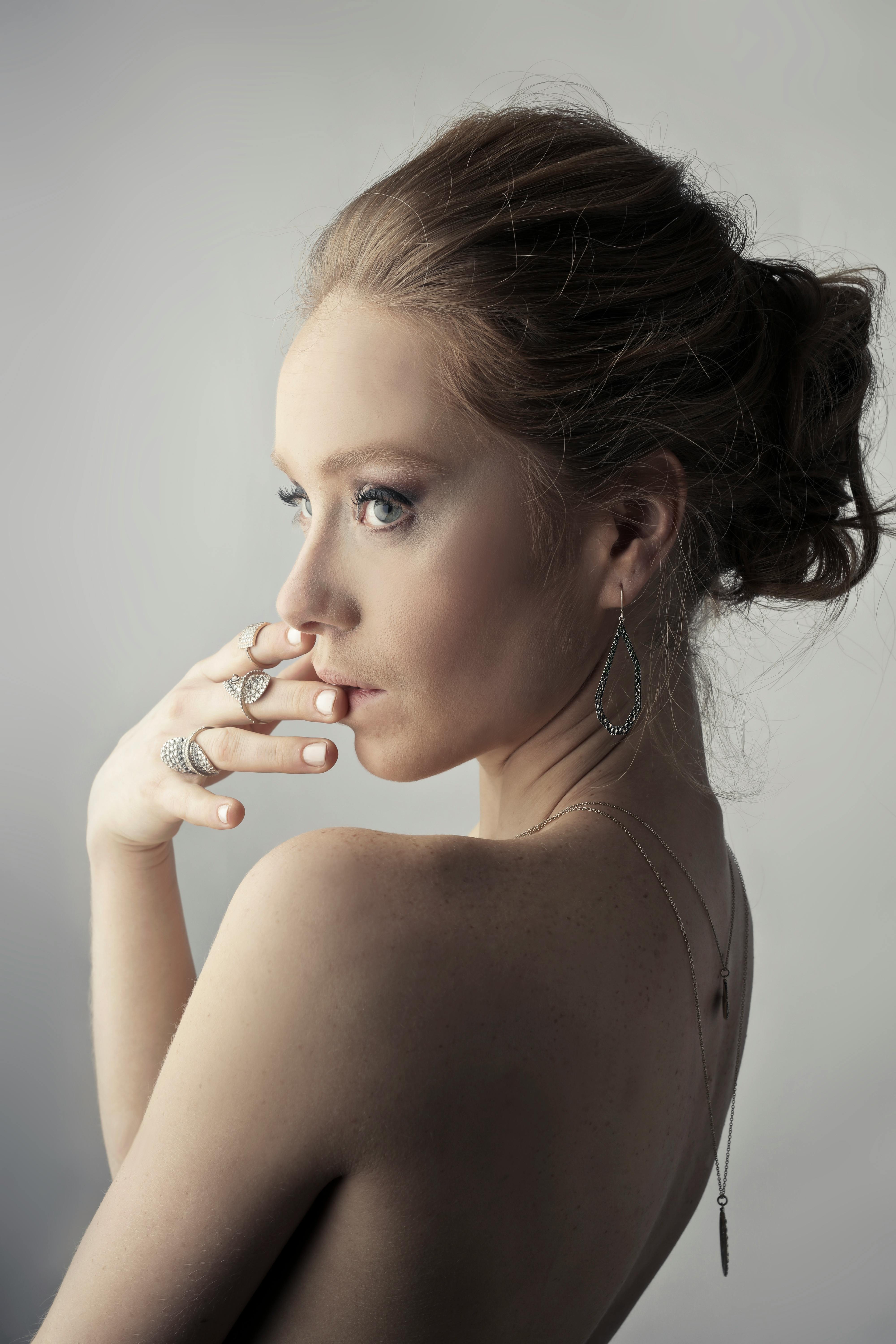 woman wearing silver colored earrings posing