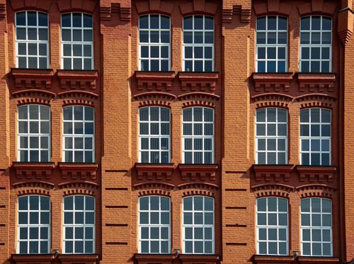Free Close-up of a classic brick building facade with symmetrical windows in Moscow, showcasing traditional architecture. Stock Photo