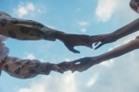 2 Person Jumping on Mid Air Under Blue Sky