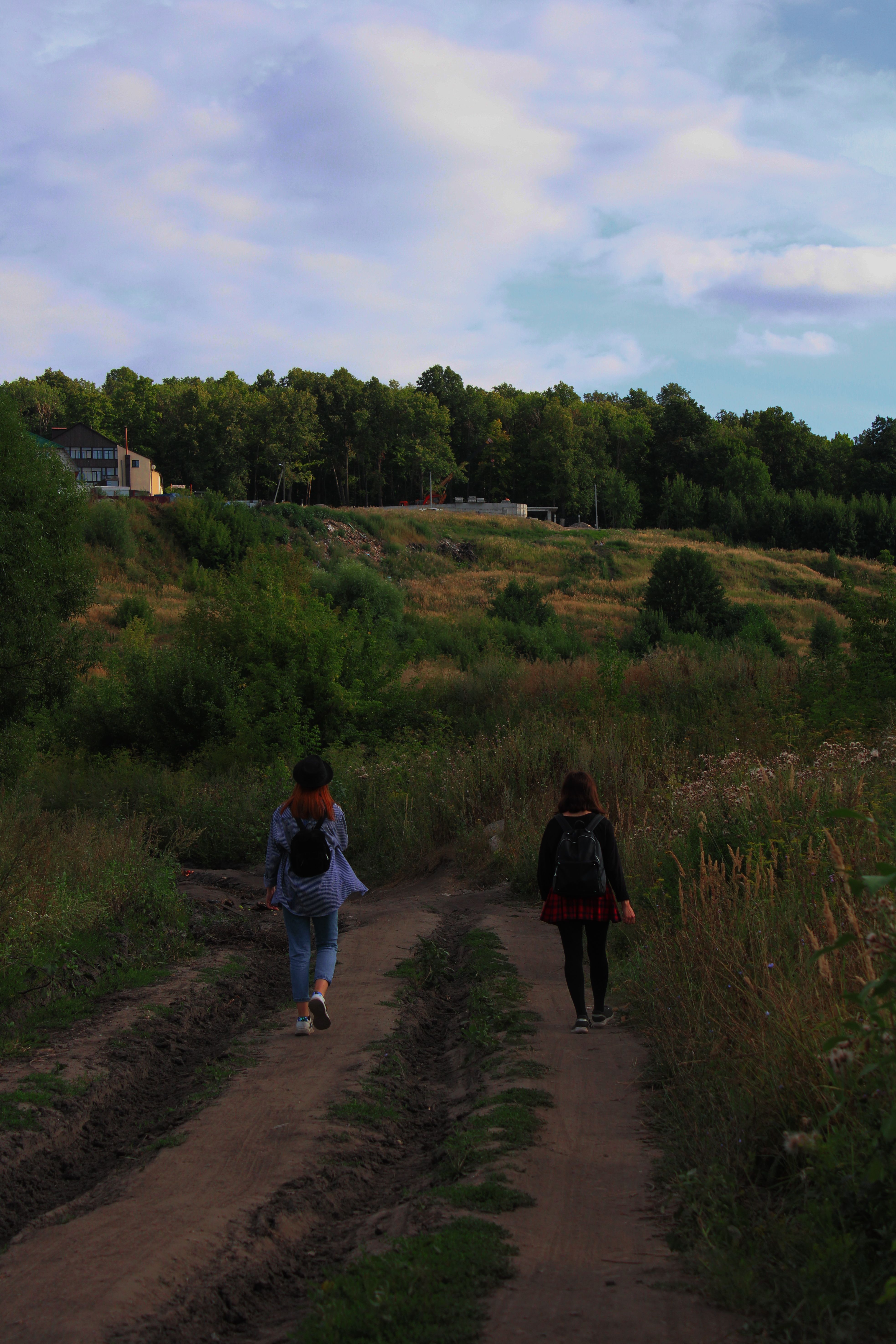 Friends walking together on a countryside trail outdoors