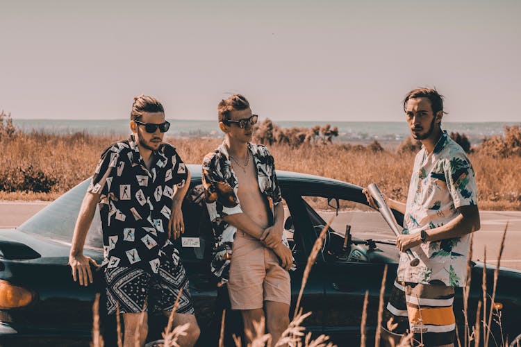 Guys In Pattern Shirts Near Car On Road