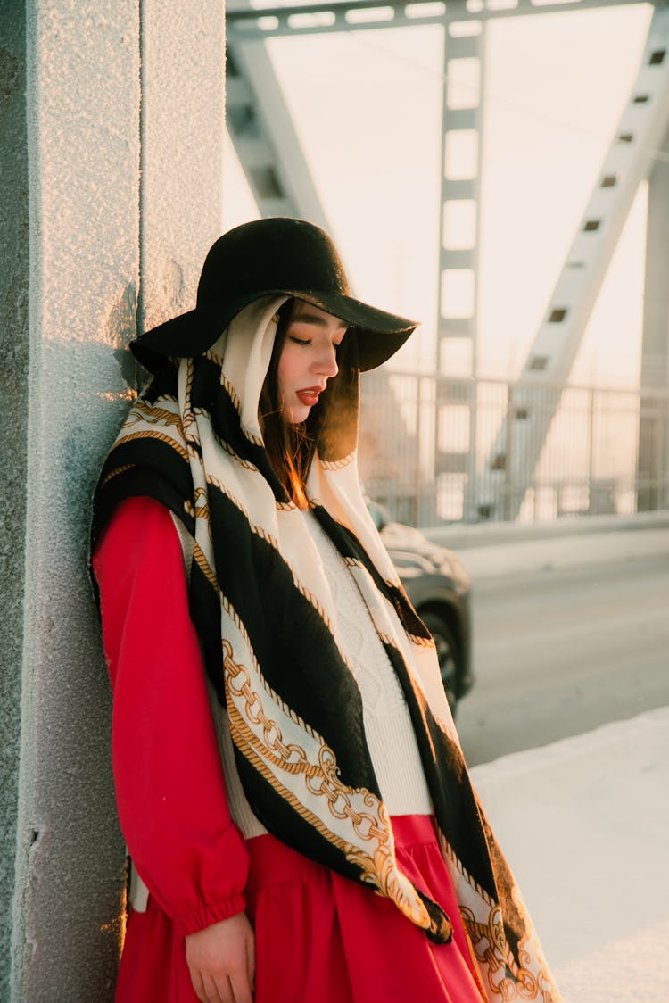 A Stylish Woman Leaning On A Steel Column